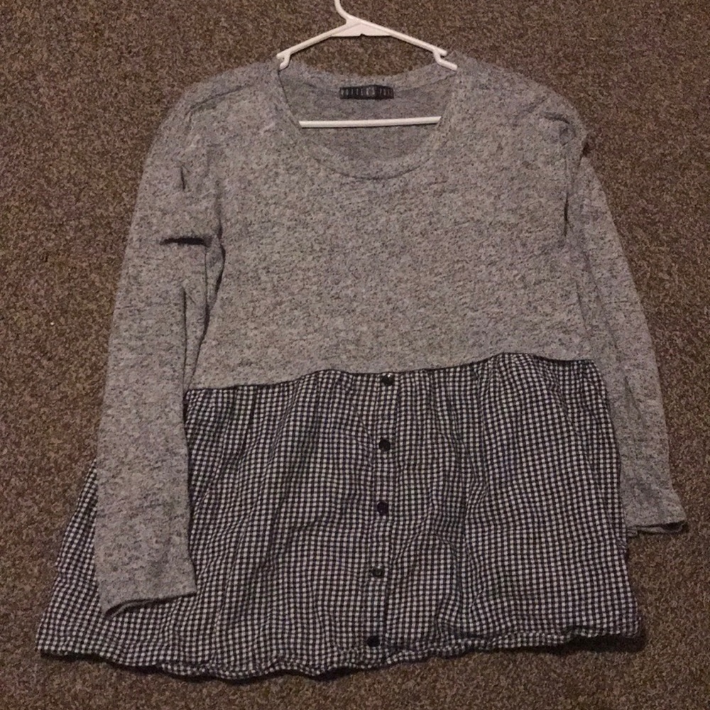 Longed sleeved sweater with checkered bottom half.